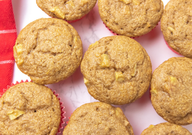 counter with apple muffins placed by each other
