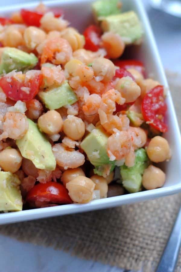 chickpea and avocado salad in a square bowl