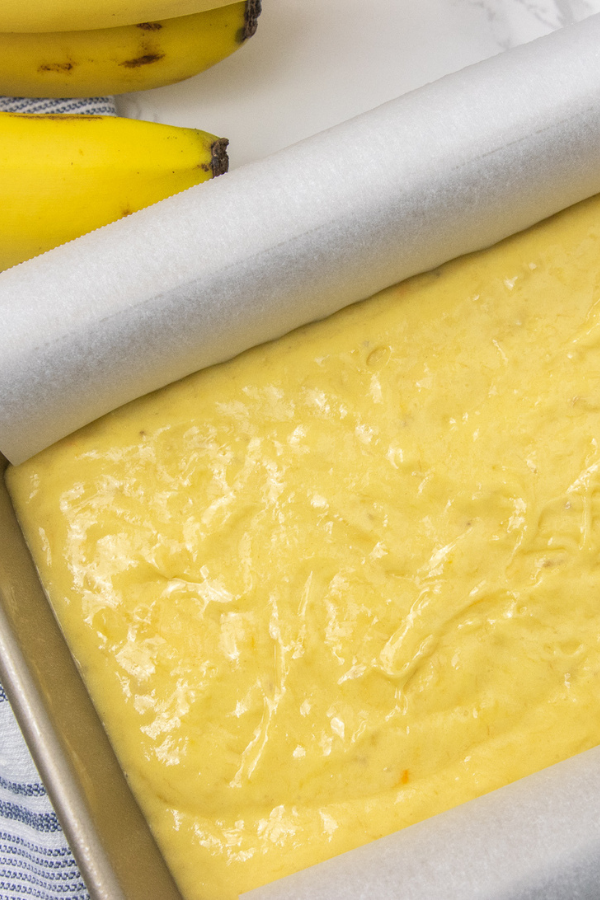 3 Ingredient Banana Bread is a super simple banana bread recipe. Cake mix is the base and fresh ripe bananas offer the rich flavor you love. #passion4savings #bread #banana #easy #baked #cakemix #freshbananas #ripebananas overhead shot of batter in pan