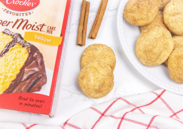 snickerdoodle cookies on counter with cake mix by it and cinnamon sticks