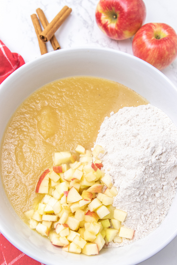 3 ingredients is all it takes to make these cake mix apple spice muffins! A delicious fresh apple muffin that is a breakfast or dessert! #passion4savings #apple #muffins #freshapples #easy #quick #cakemix #fall #fallmuffin bowl with cake mix, diced apples and apple sauce