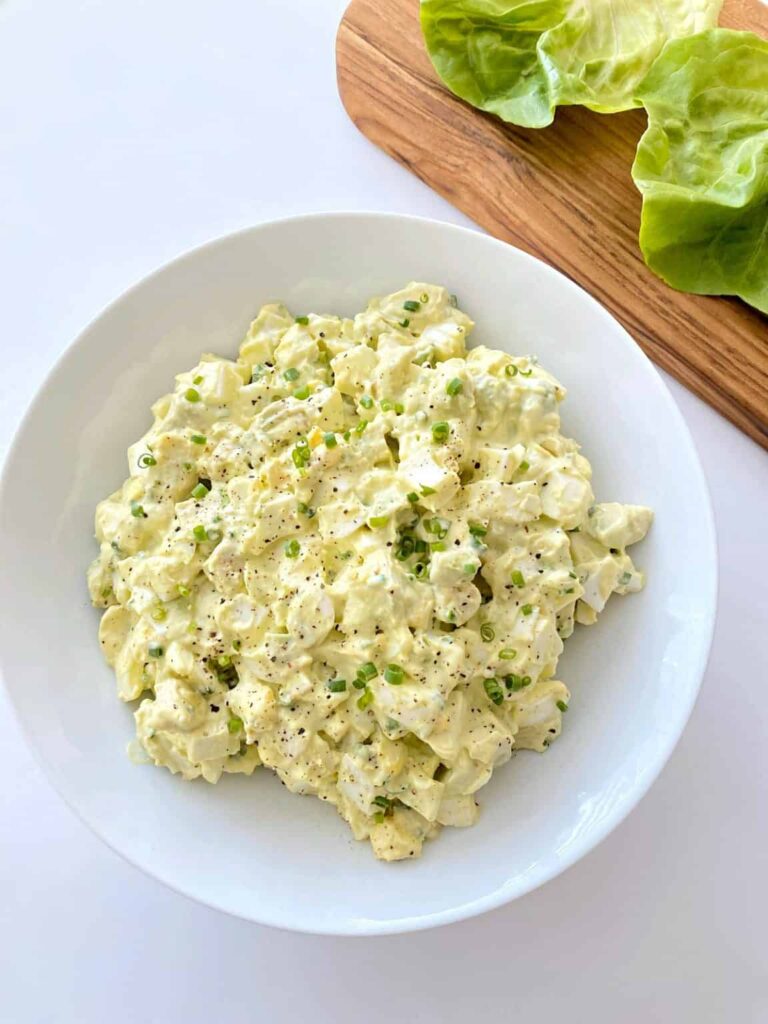 creamy avocado egg salad in a white bowl 