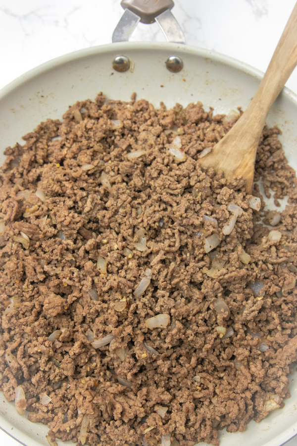 ground beef with onions in a skillets
