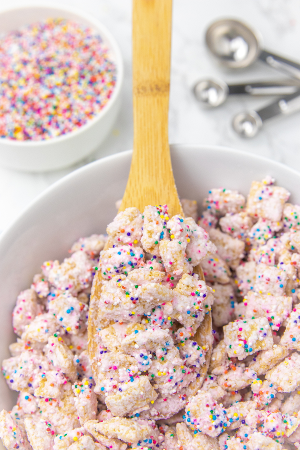 wooden spoon with puppy chow on it 