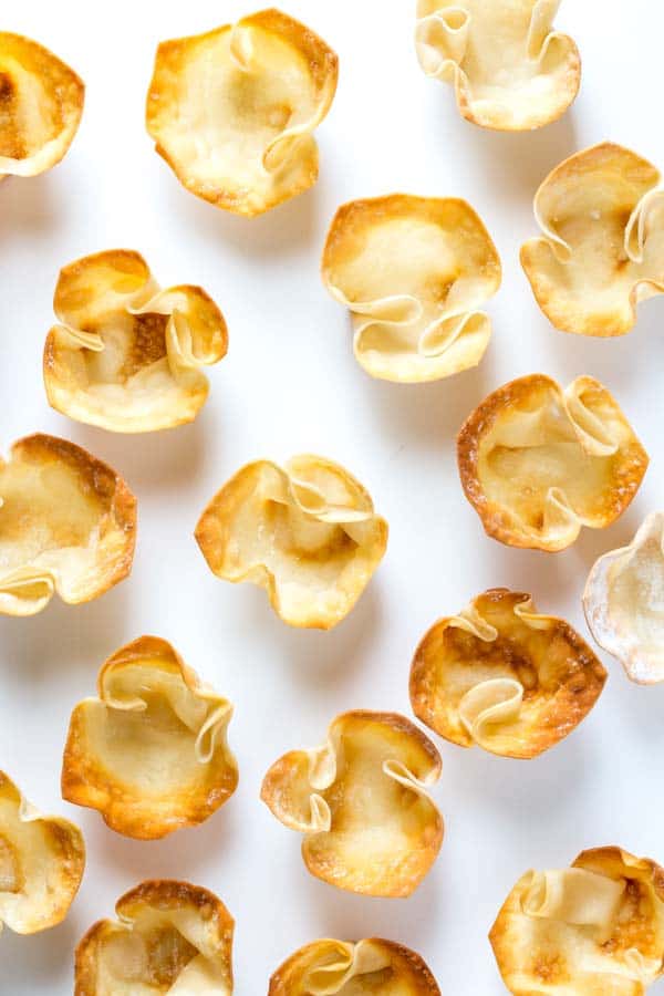 wonton cups all over a white table 