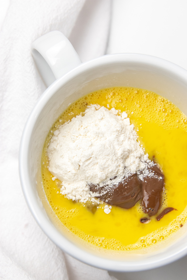 egg, flour and nutella in mug 