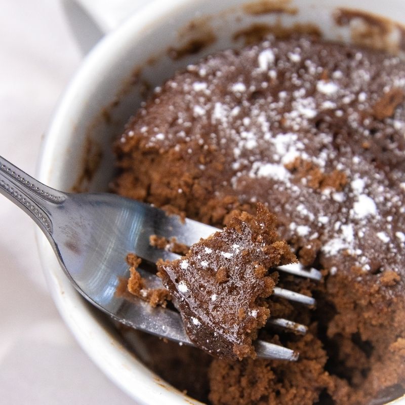 3 ingredient nutella mug cake recipe is so simple to make. Just a few ingredients is all it takes and 2 minutes to cook. A single serve treat. #passion4savings #nutella #cake #dessert #easy #homemade #mugcake #mugdessert #nutellarecipe nutella mug cake with fork with cake on it