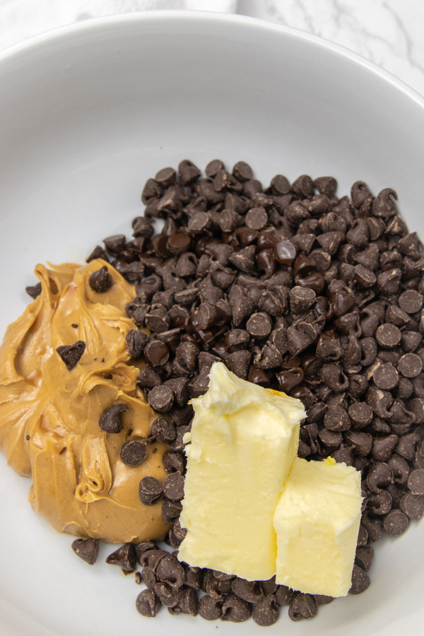 peanut butter, butter and chocolate chips in a bowl 
