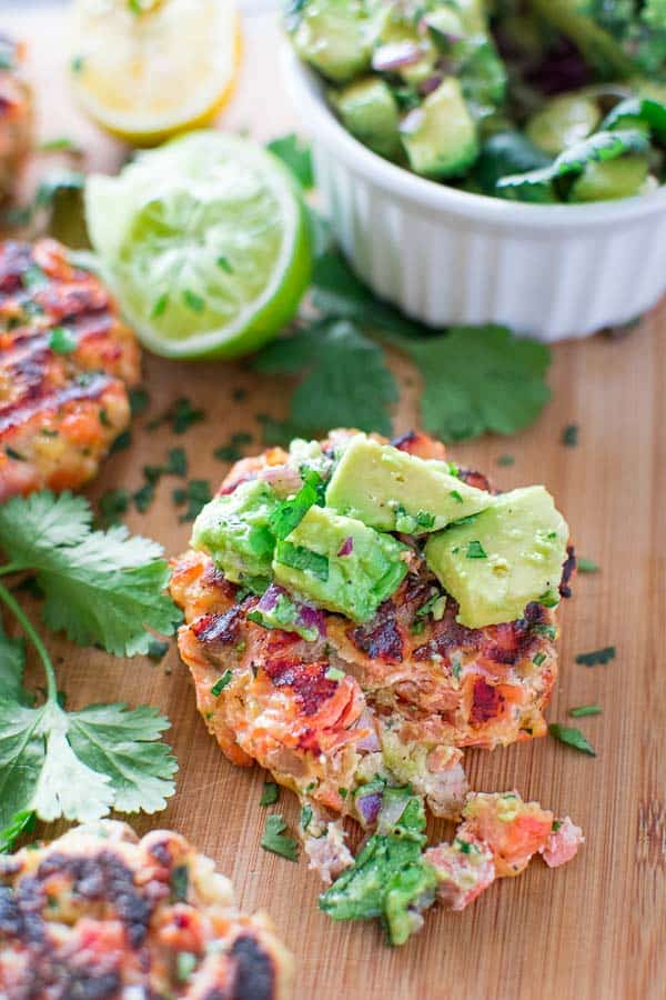 salmon burger with avocado salsa on top 