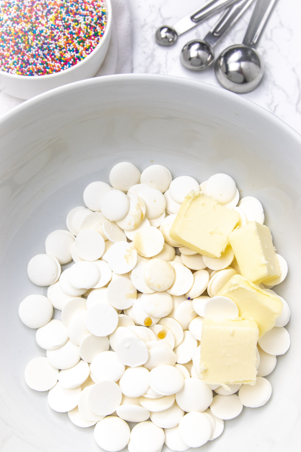 white chocolate chips and butter in a bowl 