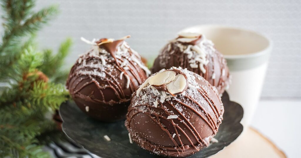 almond joy cocoa bombs on a plate on counter 