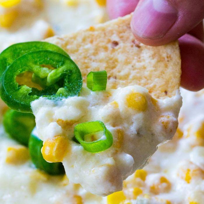 corn dip on a tortilla with jalapenos