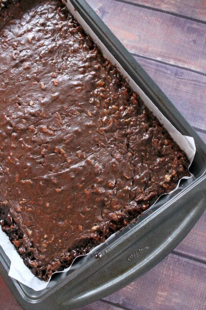 sheet pan with chocolate pecan pie bars in it 