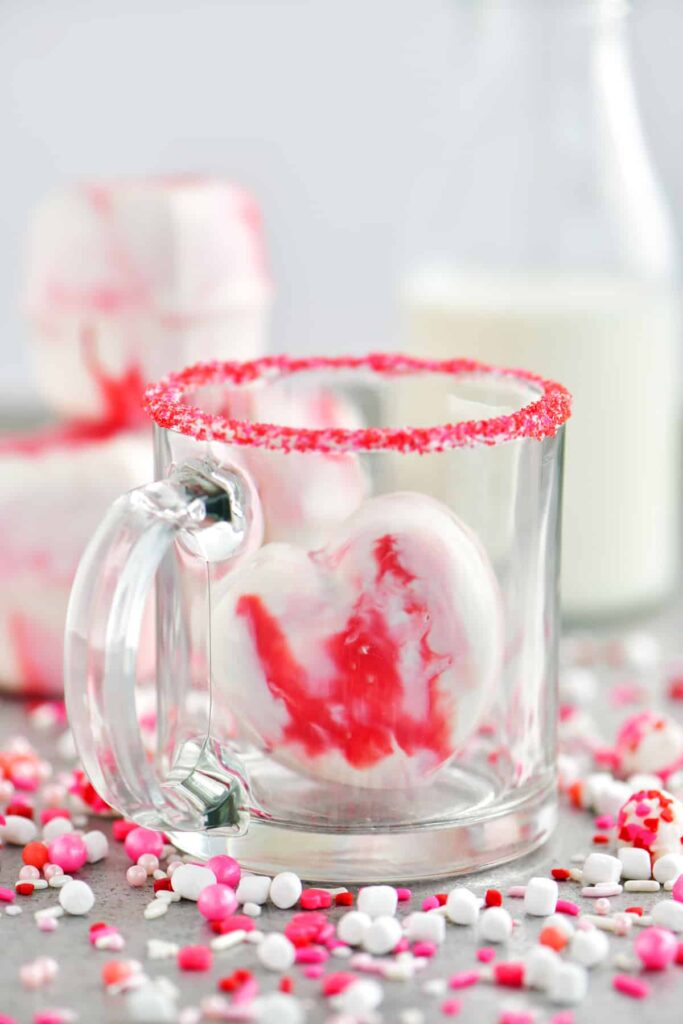 heart shaped cocoa bomb in a clear glass 