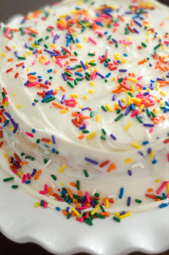 layered white cake with sprinkles 