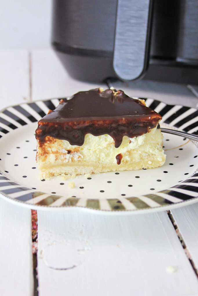 slice of Twix cheesecake on a plate on table 