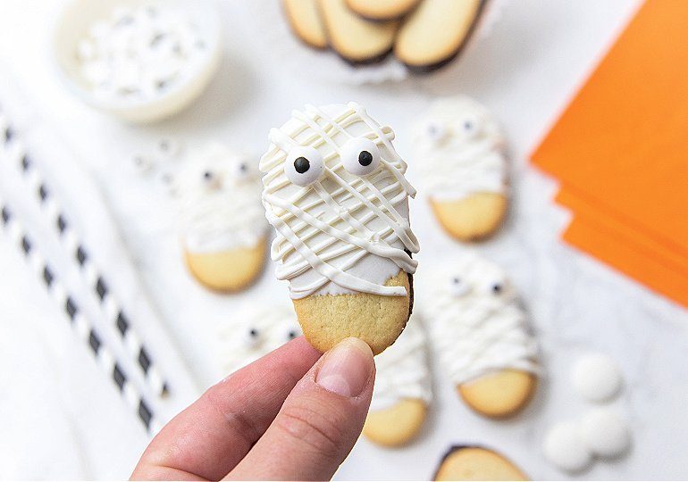 holding mummy cookie in hand