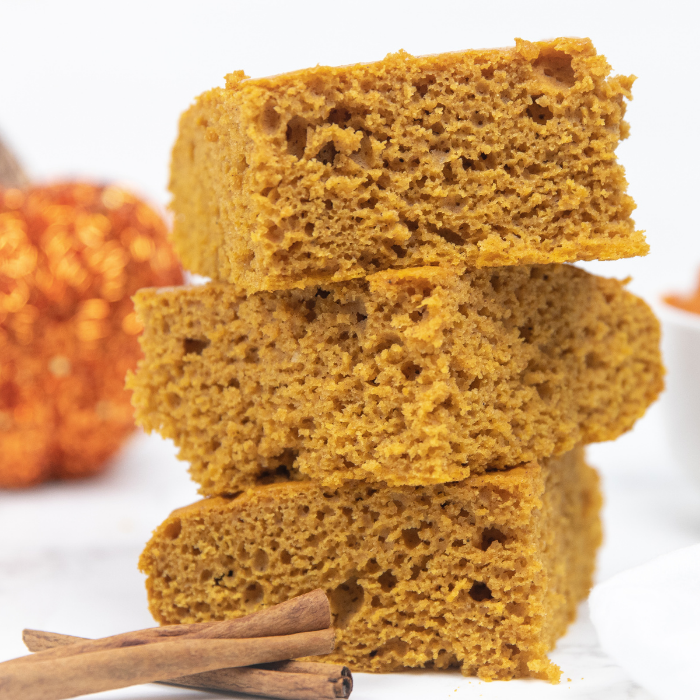 5 ingredient pumpkin cake is a simple and easy cake mix dessert. Give this recipe a try, and see for yourself. A simple pumpkin cake recipe! #pumpkin #cake #spicecake #recipe #dessert #fall #cakemix #simple #quick #autumn stacked cake on counter