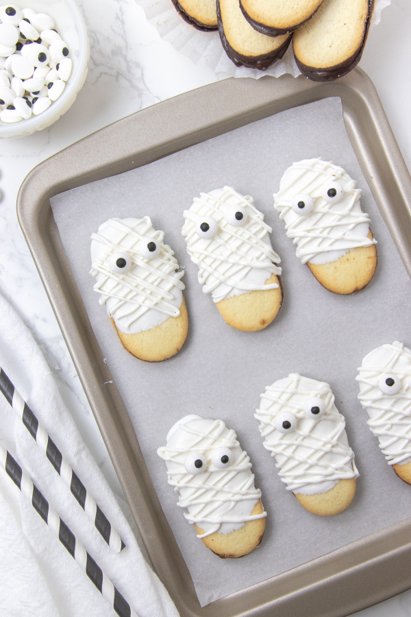Halloween Milano cookies on a baking sheet 