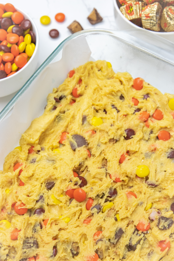 side view of raw cookie dough in baking dish