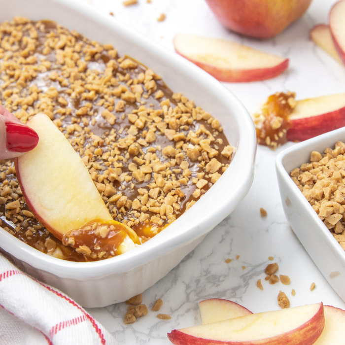 dipping apple in caramel dip
