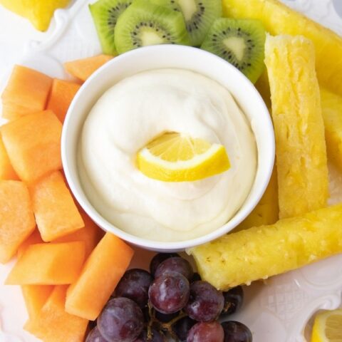 dipping apple in a caramel dip