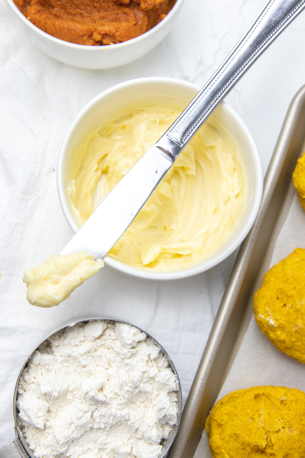 honey butter on a knife sitting on a bowl