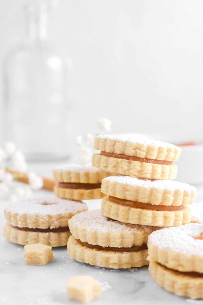 linzer cookies on tray stacked up 