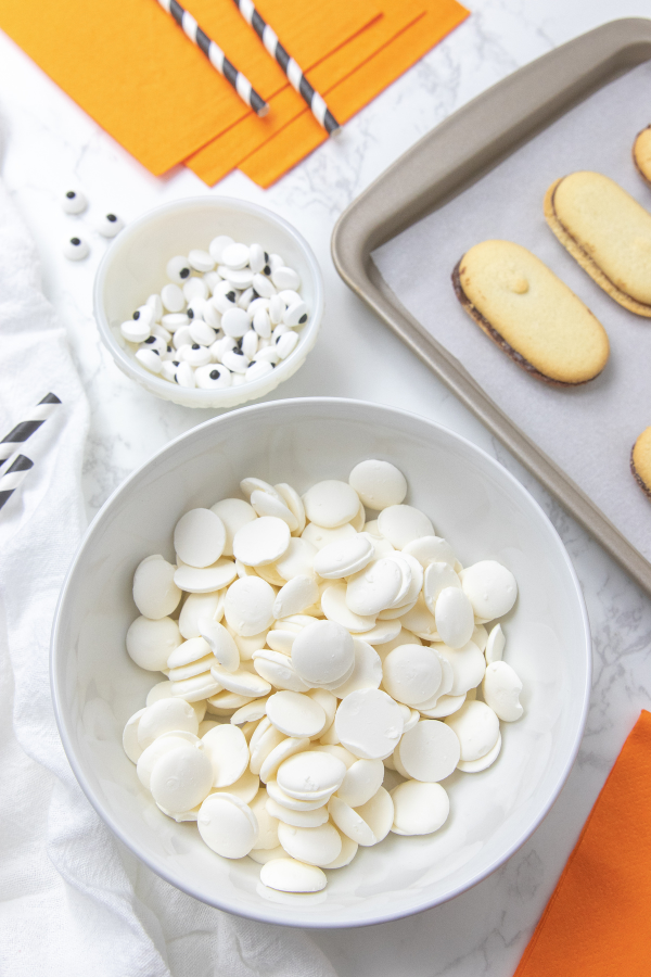 Ingredients for mummy cookies on a white table