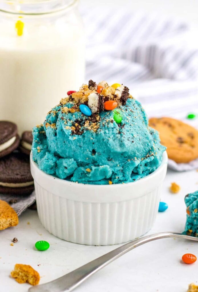 Check out these incredibly delicious Recipes for Cookie Dough Lovers! Simple, easy, and loaded with sweetness in every single bite. #passion4savings #dessert #cookiedough #easy #fun #simple #cake #cookies #cookiedoughrecipe #best #fromscratch cookie monster cookie dough in a bowl with cookies around it