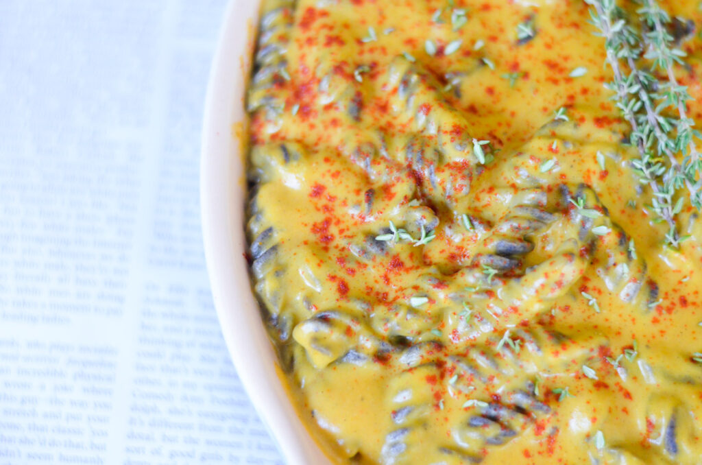 side shot of pumpkin mac and cheese in white casserole dish 