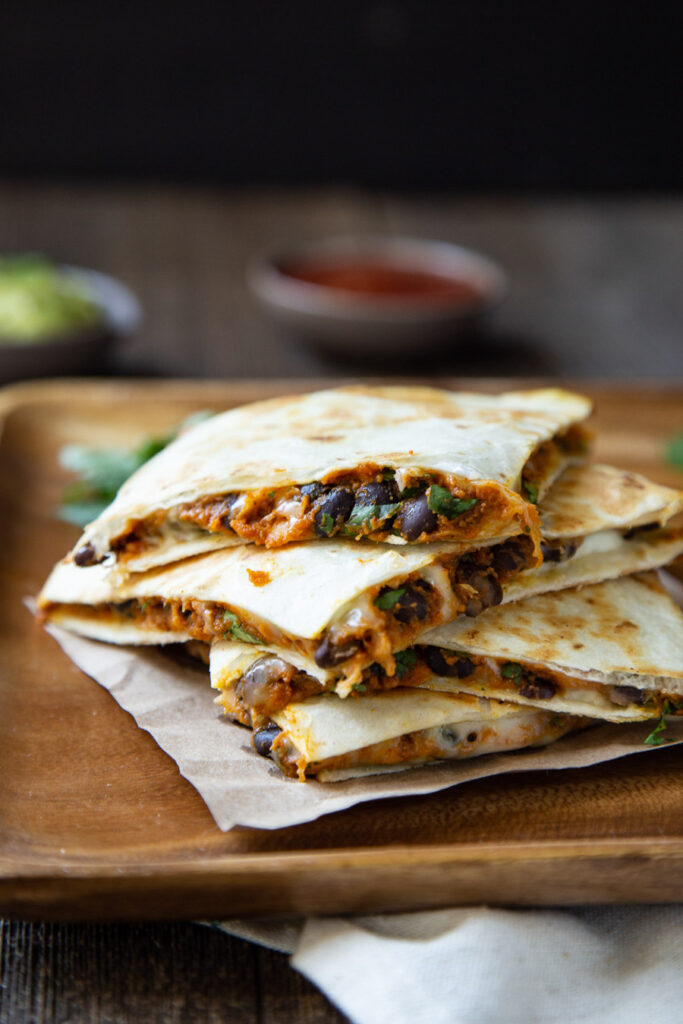 stacked quesadilla on cutting board 