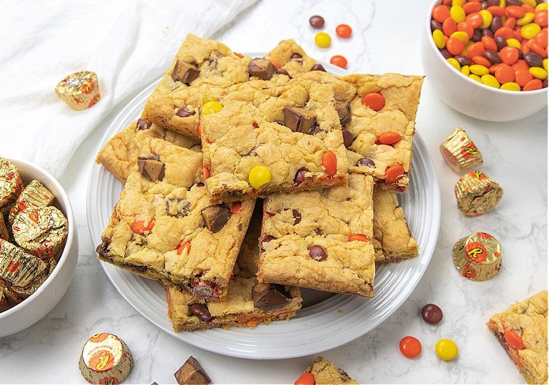 cake mix cookie bars on a plate with candies around it 