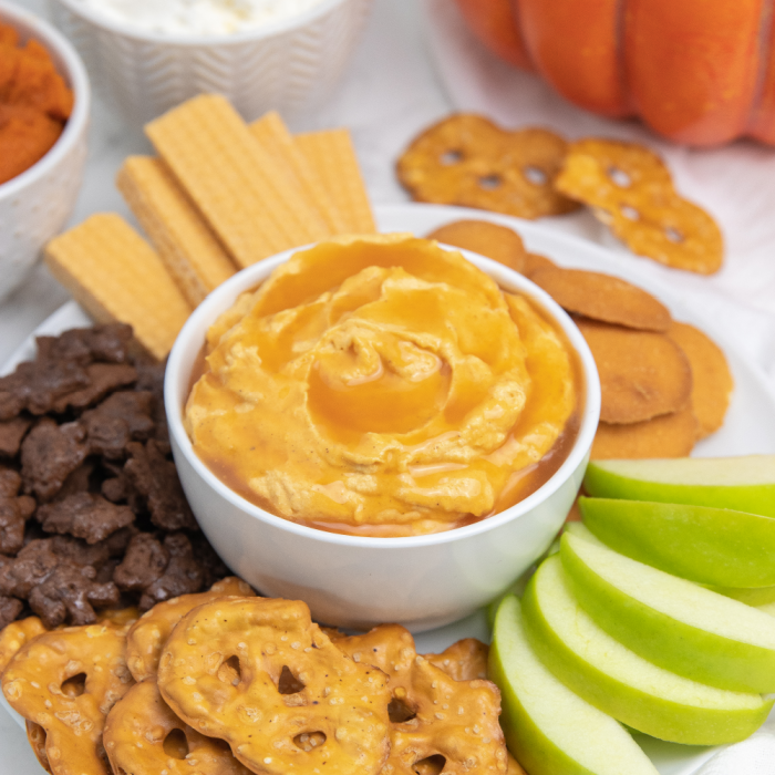 caramel dip on a plate with a fruit and other cookies