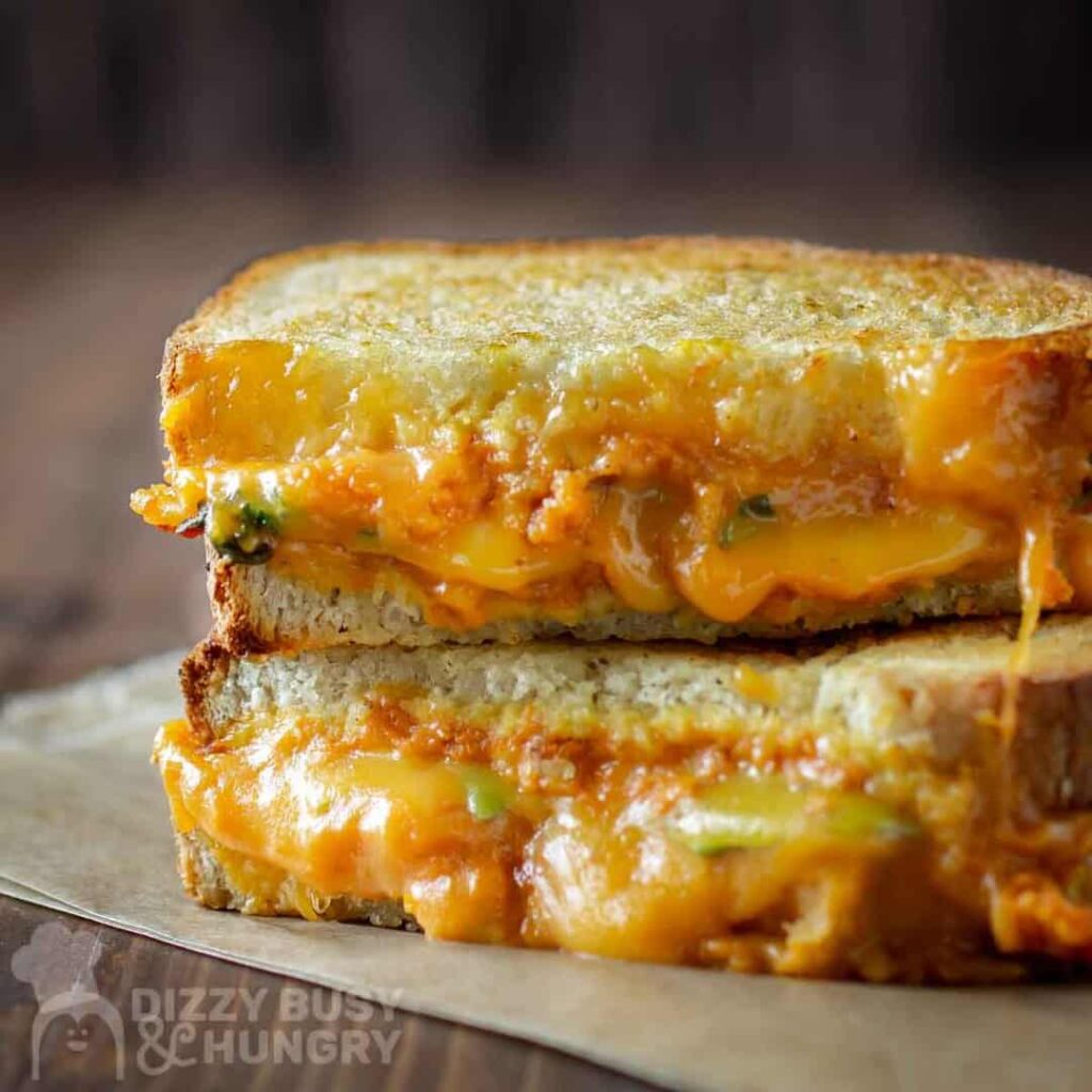 pumpkin grilled cheese stacked on parchment paper 