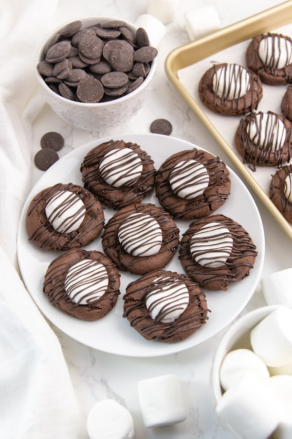 cookies on a platter with chocolate behind it