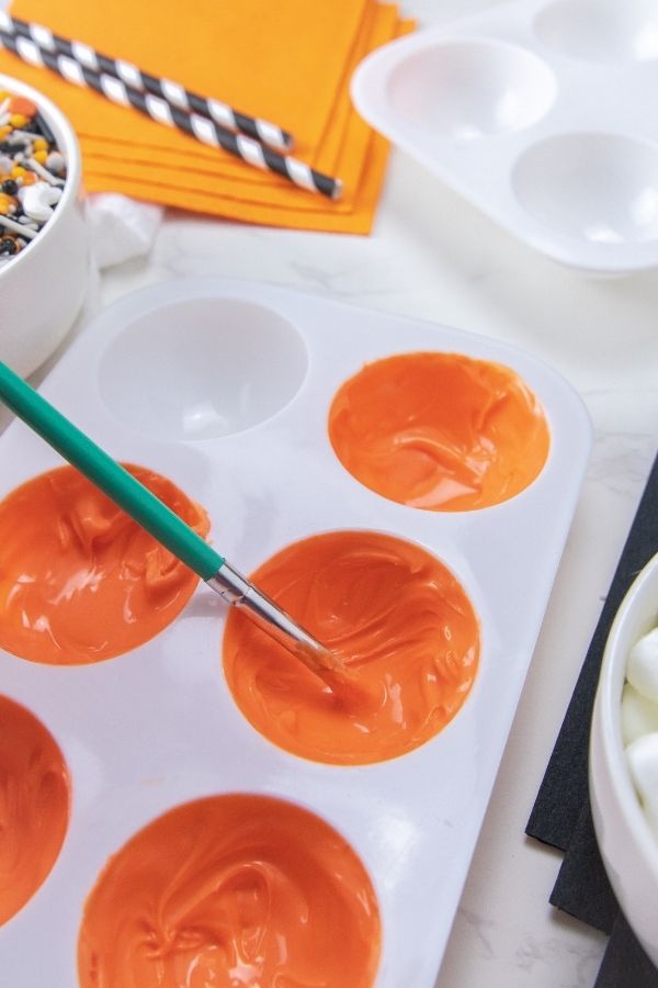 moving chocolate around in a silcone mat 