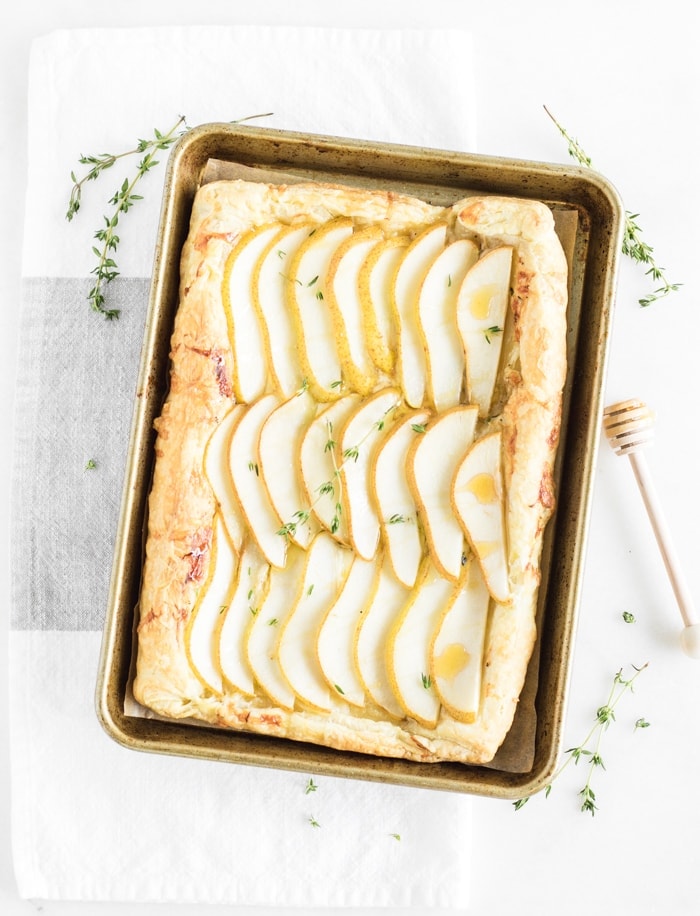 Pear tart in a baking sheet on counter 