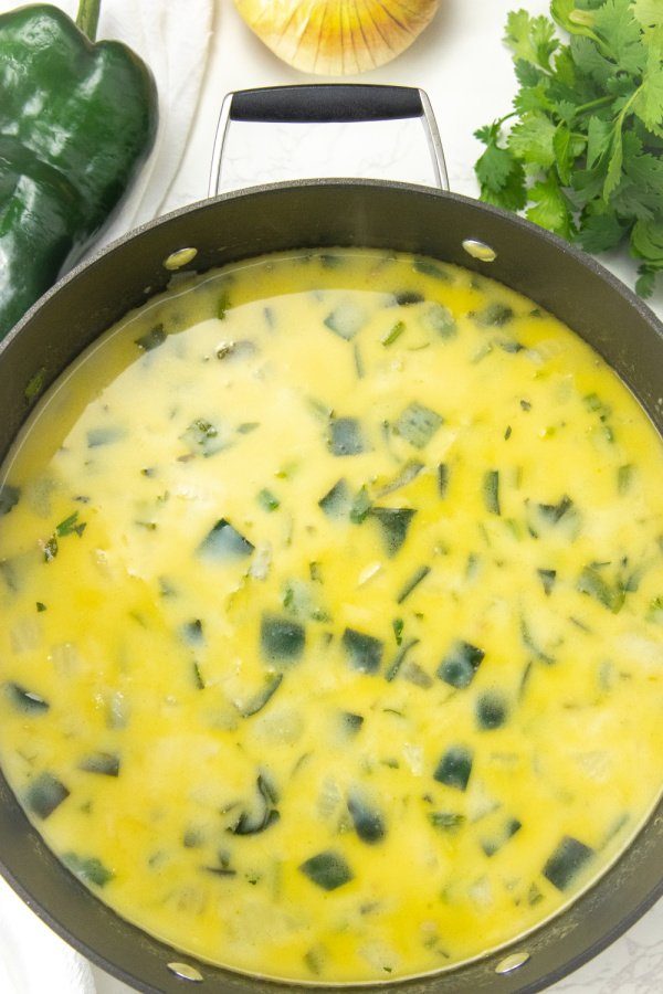 milk and broth in with veggies in a stock pot 