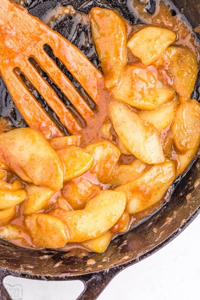 fried apples in a pan with spatula 