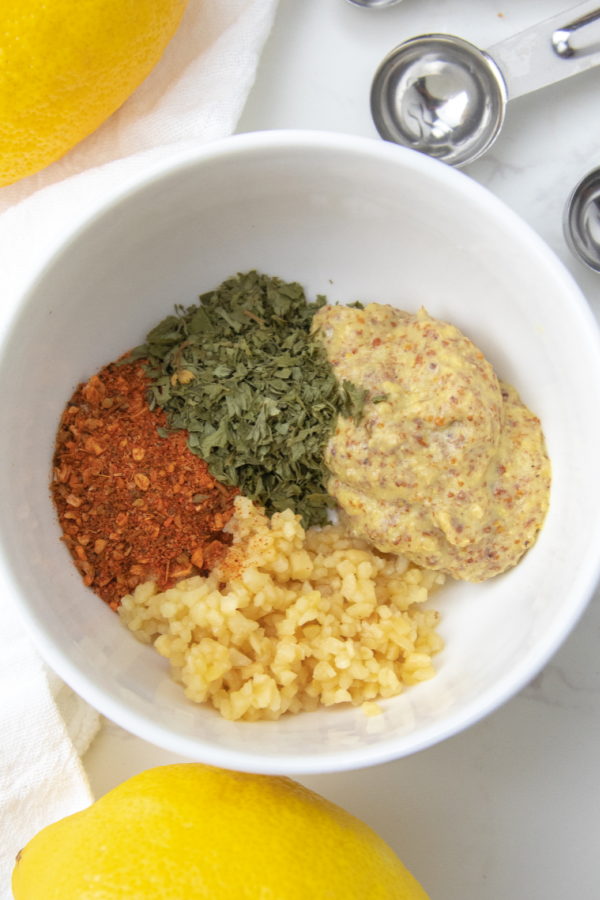 spices and herbs in a white bowl on counter 