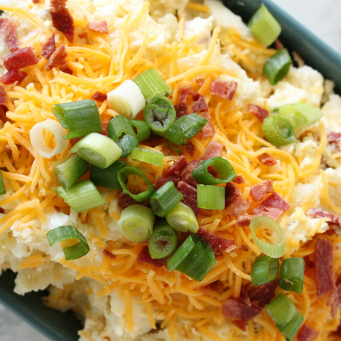 potato salad that is loaded with toppings 
