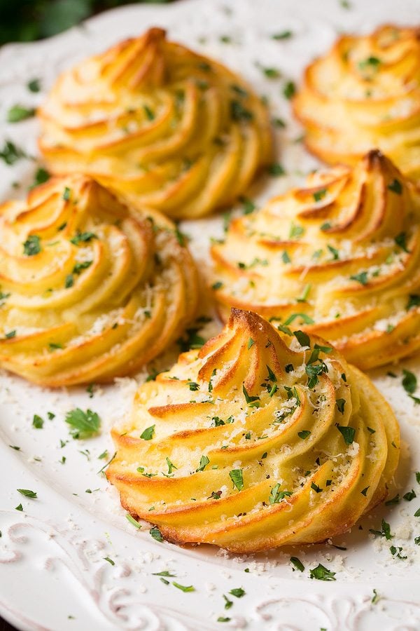 duchess potatoes on a plate garnished 
