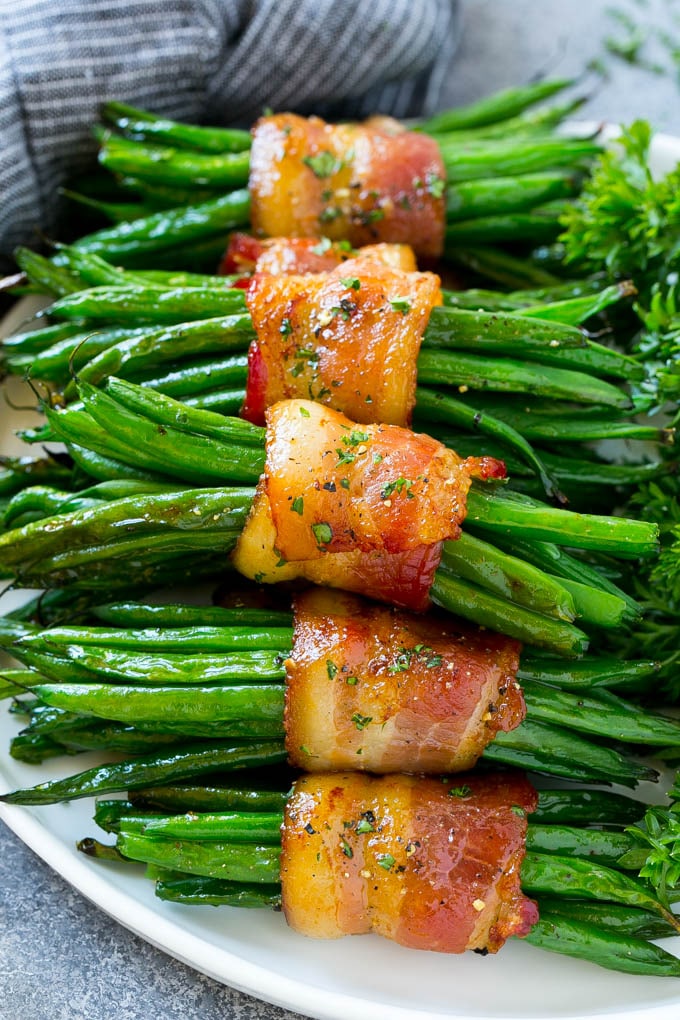 green bean bundles wrapped in bacon on plate 