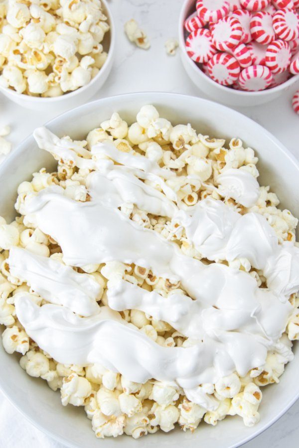 white chocolate poured over popcorn
