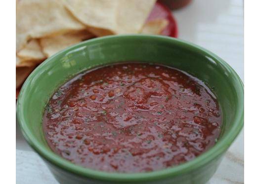 salsa in a green bowl on counter