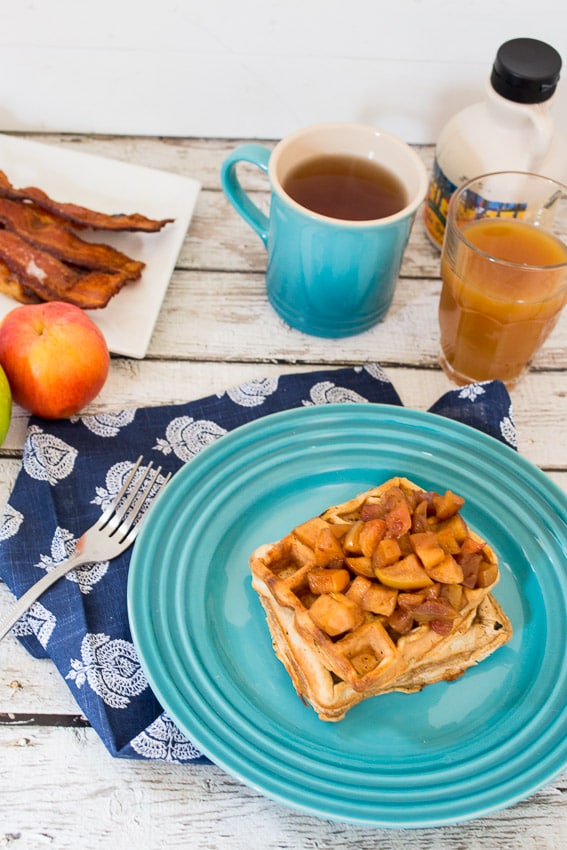 apple cider pancake on plate with apples on top 
