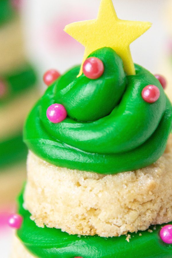 Whip up a batch of these sugar cookie Christmas Trees! These are a 3D cookie that are a stacked cookie that is festive and delicious. #passion4savings #Christmas #cookies #dessert #holiday #xmas #sugarcookie #frosting Close up of Christmas sugar cookies