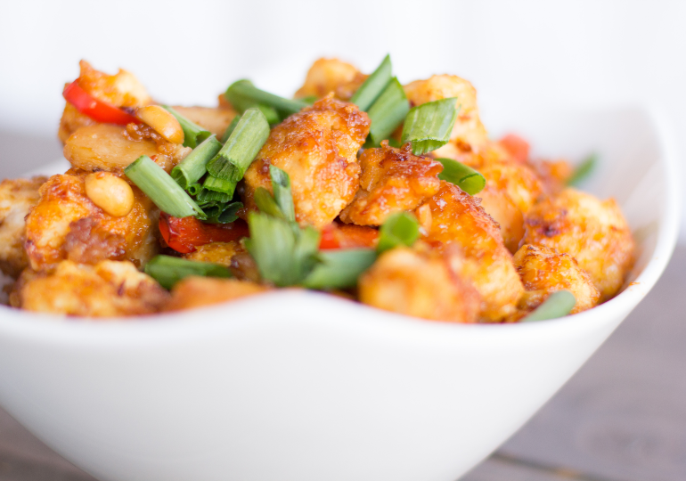 side view of chicken with green onions on top