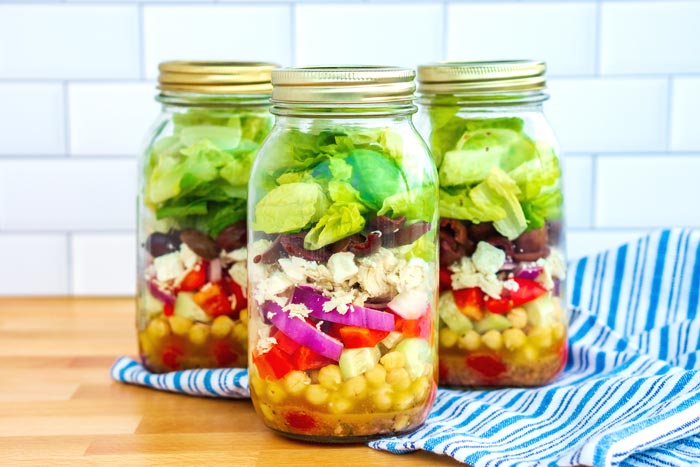 greek mason jar salads with towel under it 